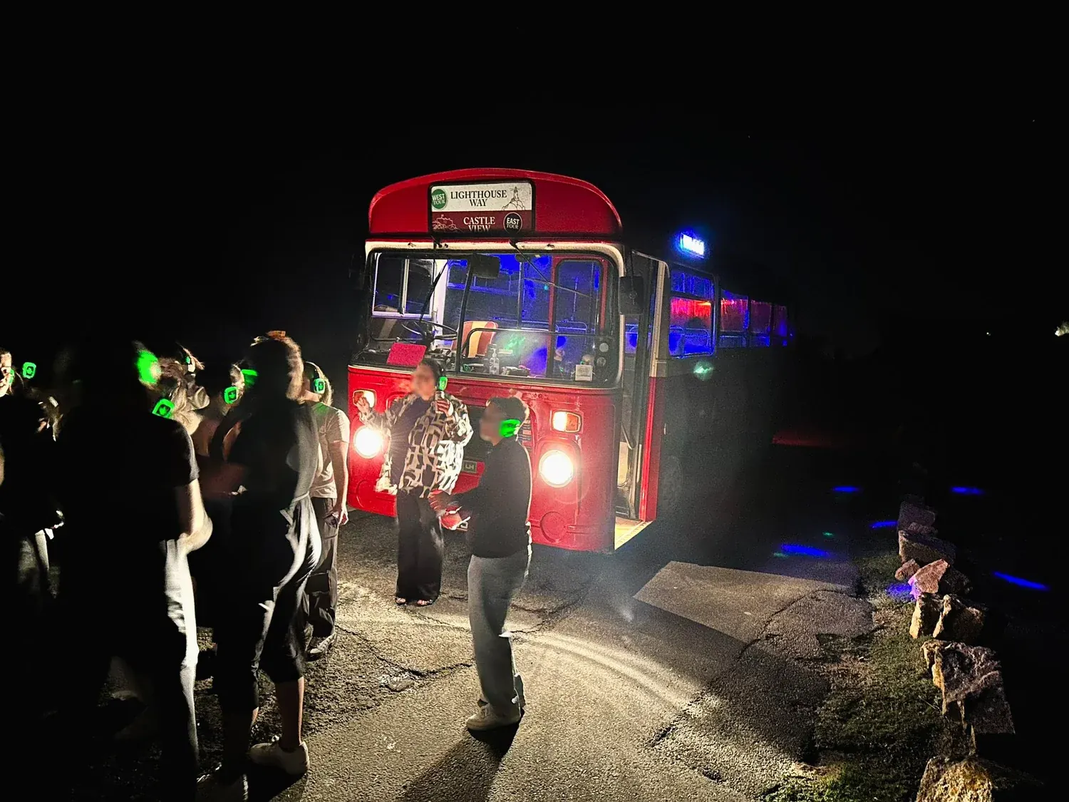 Party bus and glowing headphones under the night sky