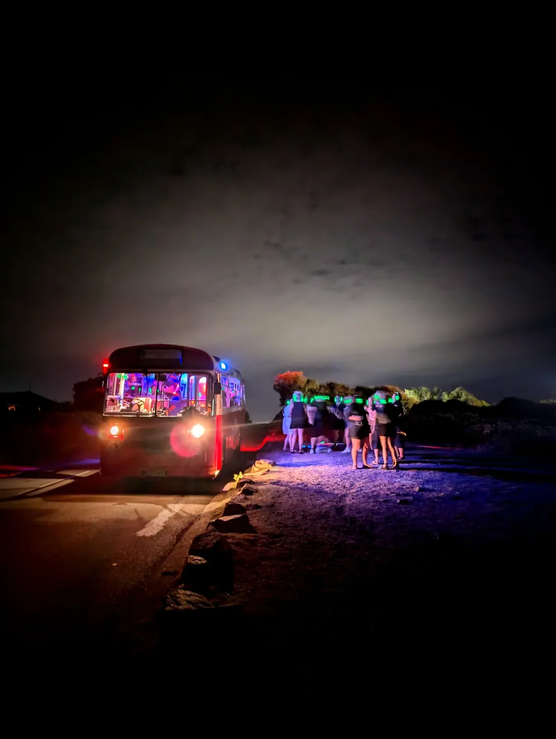 The Jersey silent disco party bus lit up at night